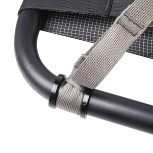 Close up of grey webbing strap attached to black metal frame