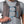 Person wearing a grey Nathan hydration vest with blue bungee cord adjustments