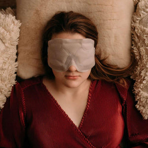 Person wearing an Opal Cool beige eye mask while lying on a pillow