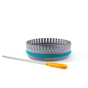 Grey cake slicing guide with teal ring and metal cake tester with yellow handle