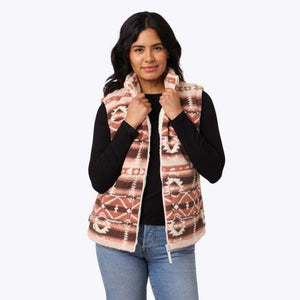 Woman wearing a Mobile Warming patterned fleece vest over a black long sleeve shirt
