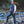 Man wearing an ActionHeat black puffer vest standing on rocks by a stream