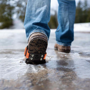 Impacto ice cleats on boots walking on icy ground
