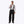 Man wearing Mobile Warming black snow pants with suspenders and a grey long sleeve shirt