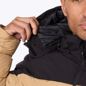 Close up of a person adjusting the hood of a tan and black Mobile Warming jacket