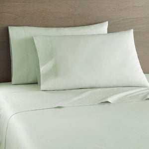 Shavel sage green bed sheet set with two pillows on a bed