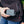 Person holding an ActionHeat power bank connected to a black jacket pocket