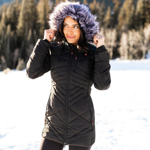 Woman wearing a black quilted winter jacket with a faux fur hood in a snowy outdoor setting