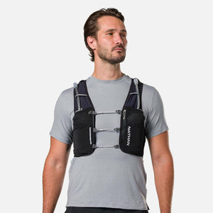Man wearing a black Nathan hydration vest over a grey t-shirt
