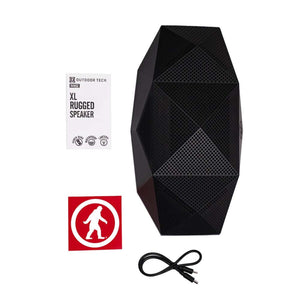 Outdoor Tech Range XL rugged speaker with product packaging, sticker, and charging cable