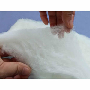 HealthyLine white polyester fiberfill batting material held by hands