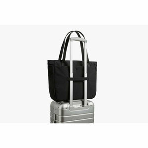 Bellroy black tote bag attached to a silver luggage handle