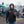Man wearing Seattle Seahawks branded jacket and beanie holding a football at a tailgate party