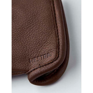 Brown leather Hestra glove detail with embossed logo