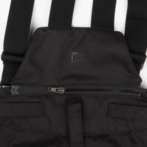 Black bib overalls featuring adjustable straps and a zippered chest pocket with a Norrona logo
