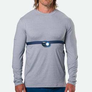 Person wearing a Nathan chest light with an illuminated LED beam