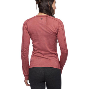 Back view of a woman wearing a red Black Diamond long sleeve base layer shirt