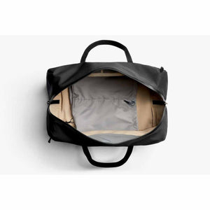Open Bellroy black duffel bag with tan interior lining and grey internal pocket