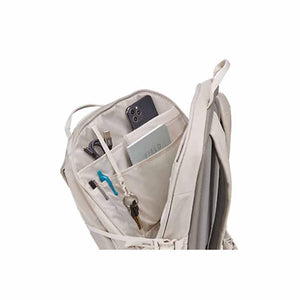 Open Thule backpack showing internal organization pockets with phone notebook pens and keys