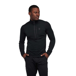 Man wearing a black Black Diamond long sleeve quarter zip shirt
