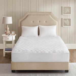 Beautyrest white quilted mattress pad on a bed