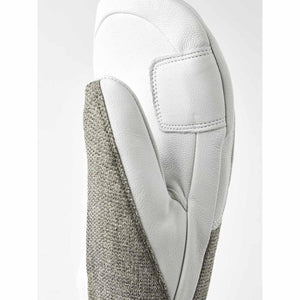 Close up of white leather and grey textile mitten