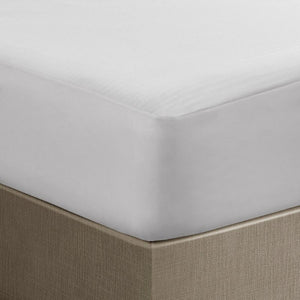 White mattress protector fitted on a bed corner