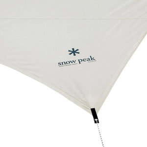 Snow Peak logo printed on a beige fabric tarp corner with a guy line attachment