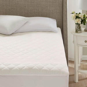 Beautyrest white quilted mattress pad on a bed
