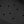 Black textured surface with a repeating hexagonal pattern and evenly spaced circular holes