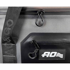 Close up of grey AO Coolers bag with black zipper pulls and branded strap