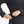 Person inserting a portable battery pack into a side pocket of a black long sleeve shirt
