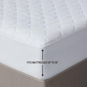White quilted mattress protector with text indicating it fits mattresses up to 18 inches deep