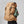 Person wearing a tan FjallRaven Kajka 55 backpack from the side