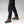 Person wearing black Fjallraven G-1000 trekking trousers and brown leather hiking boots