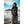 Woman wearing a black long sleeve quarter zip shirt and grey cargo pants standing in a snowy landscape