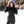 Woman wearing a black ActionHeat quilted parka with a faux fur hood in a snowy landscape