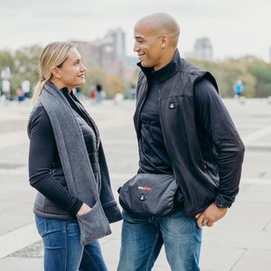 Man and woman wearing ActionHeat heated vests and accessories outdoors