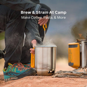 Person using a BioLite kettle pot to strain food over a camp stove