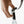 Hand using a Bellroy bottle opener attached to a strap to open a glass soda bottle