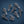Group of seven metal screws with hex heads on a dark blue background