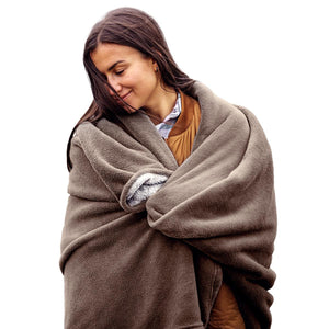 Woman wrapped in a brown fleece blanket