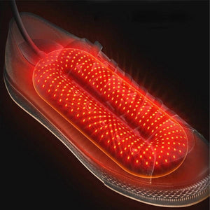 Electric shoe dryer insert glowing red inside a sneaker