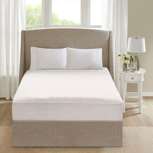Beautyrest white quilted mattress pad on a bed