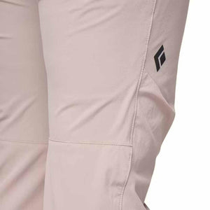 Close up of light pink Black Diamond pants with logo on the thigh
