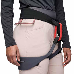 Black Diamond climbing harness worn over light pants