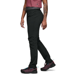 Side view of Black Diamond black hiking pants on a person wearing dark hiking shoes
