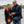 Woman wearing ActionHeat heated scarf and gloves while man wears ActionHeat heated vest looking at a smartphone