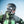 Person wearing a black Smith helmet and goggles with a green North Face jacket in a snowy environment