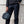 Person holding a dark Thule travel organizer by the top handles
